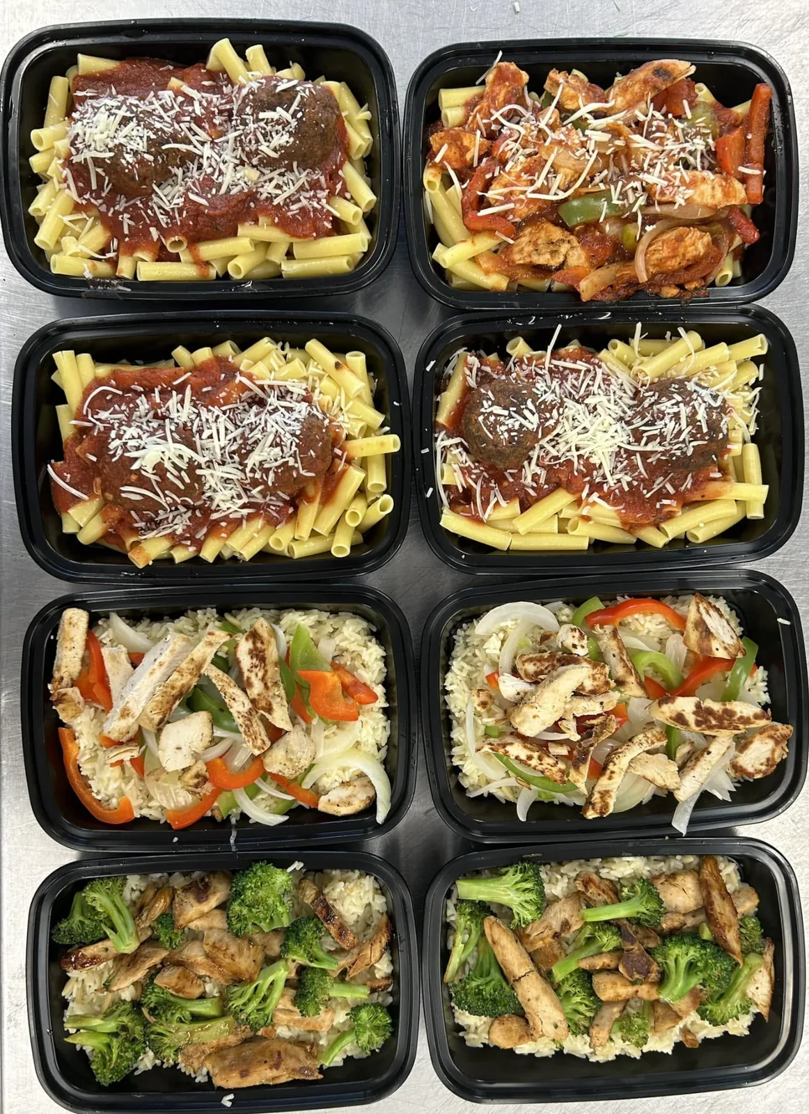 Individual hot meals — pasta, rice and grilled chicken